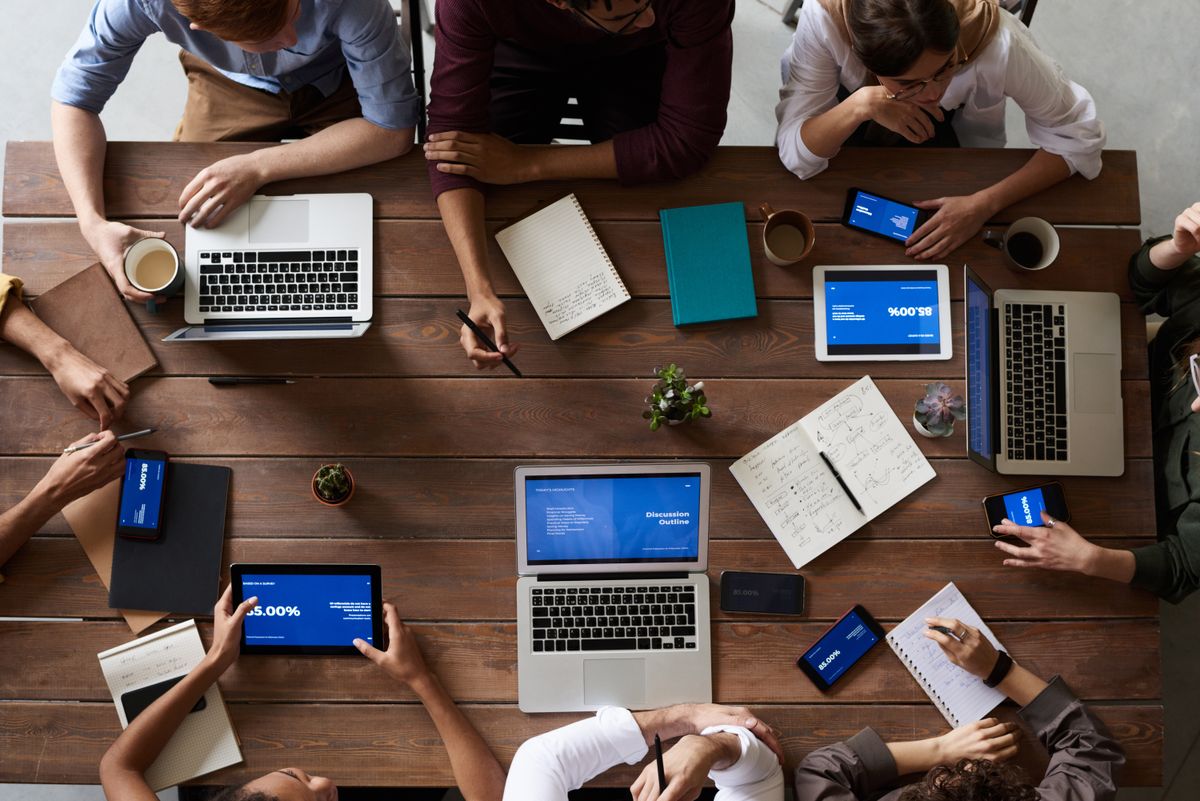 A team collaborating around a table of devices